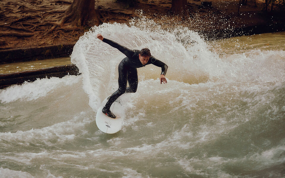 River surfing at the Eisbach in Munich Sebastian Kuhn takes a turn while surfing on the Eisbach wave