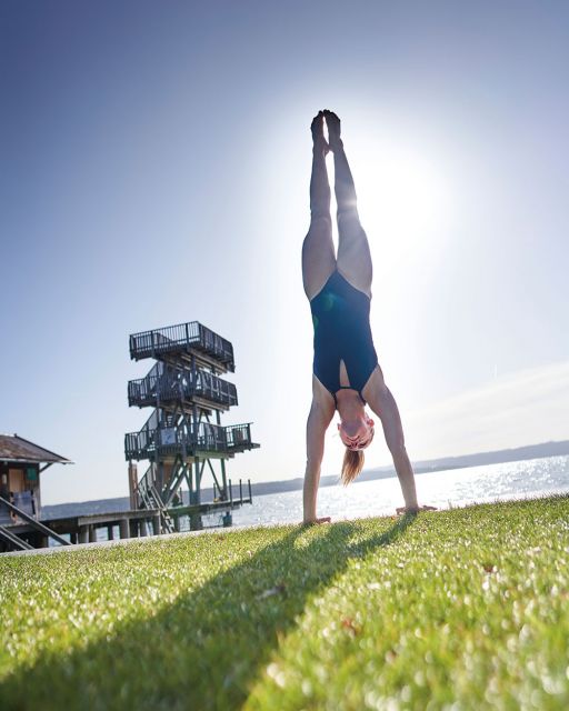 Interview Iris Schmidbauer Ammersee Iris Schmidbauer does a handstand in front of a diving platform at the Ammersees