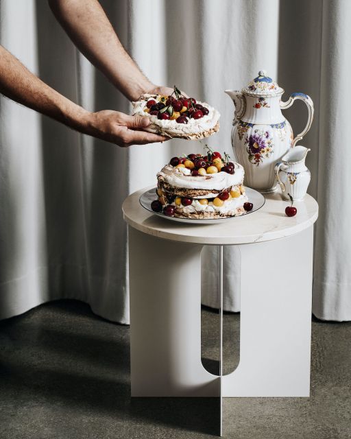 Snack de luxe: Scandinavian delicacies served on royal porcelain from KPM Man's arms are holding a fruit cake in front of small table with more cake and tea tableware