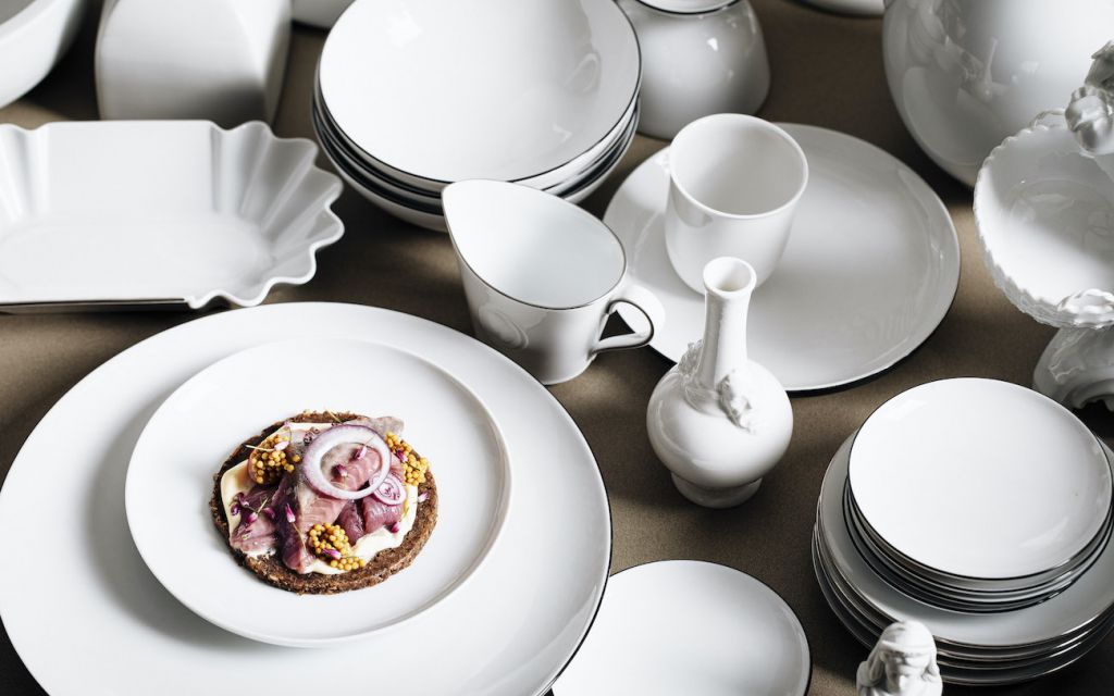 Snack de luxe: Scandinavian delicacies served on royal porcelain from KPM White porcelain with served snack is placed on a table