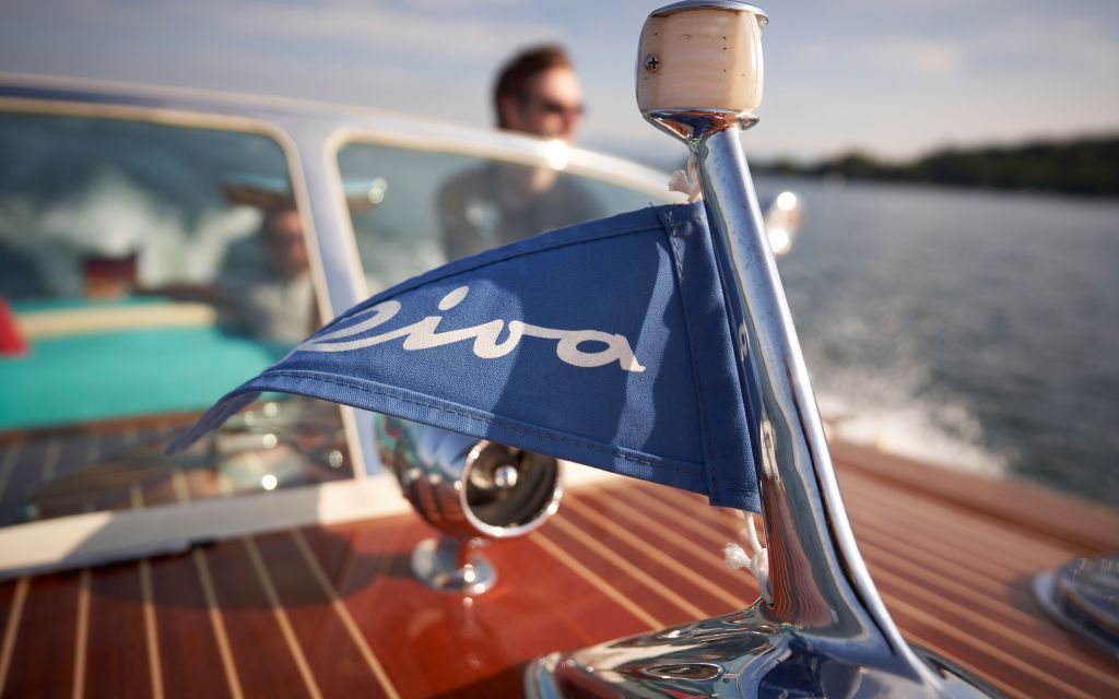 Riva Classics on Starnberger See for SeeMagazin 2021 Small boat flag with Riva lettering waving in the breeze