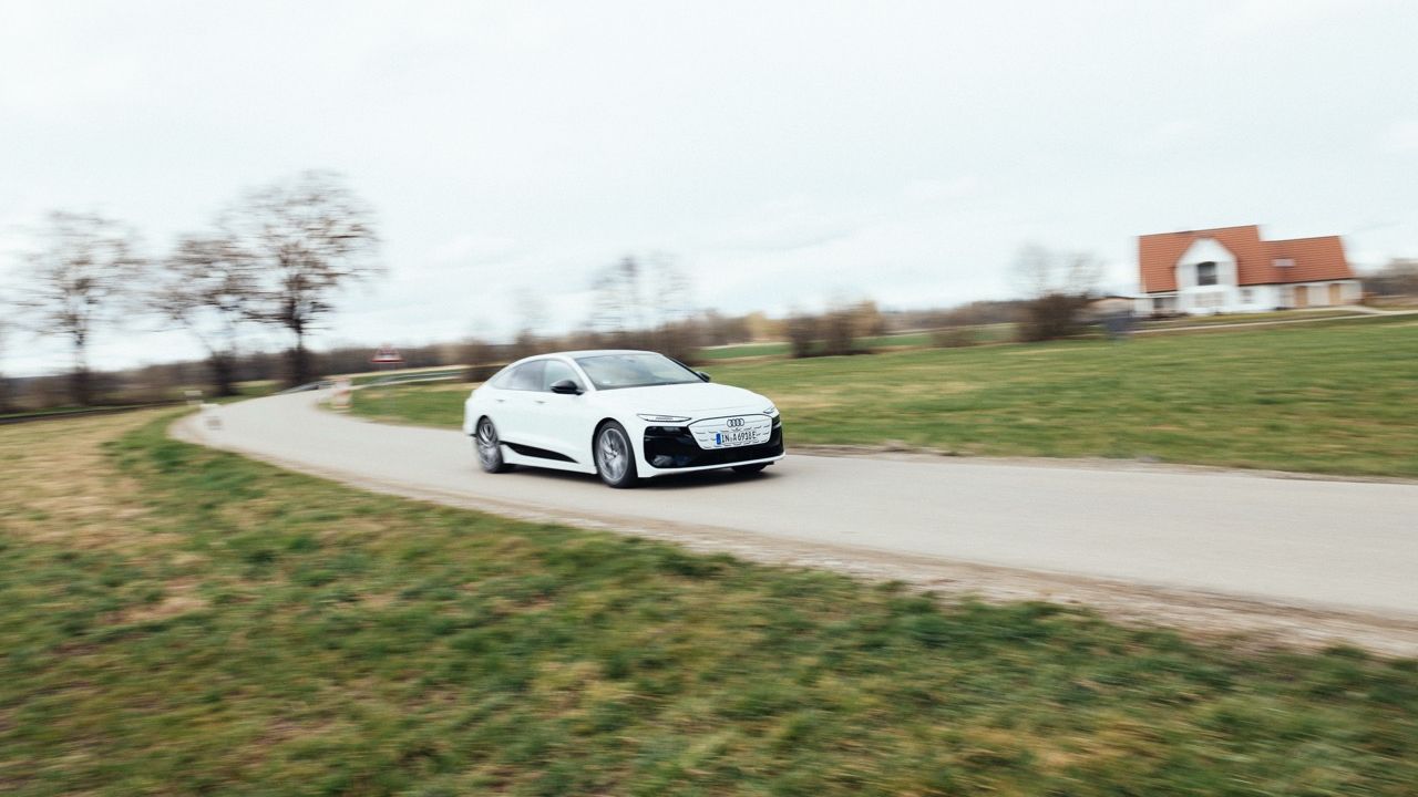 White Audi A6 Sportback e-tron driving on a winding country road